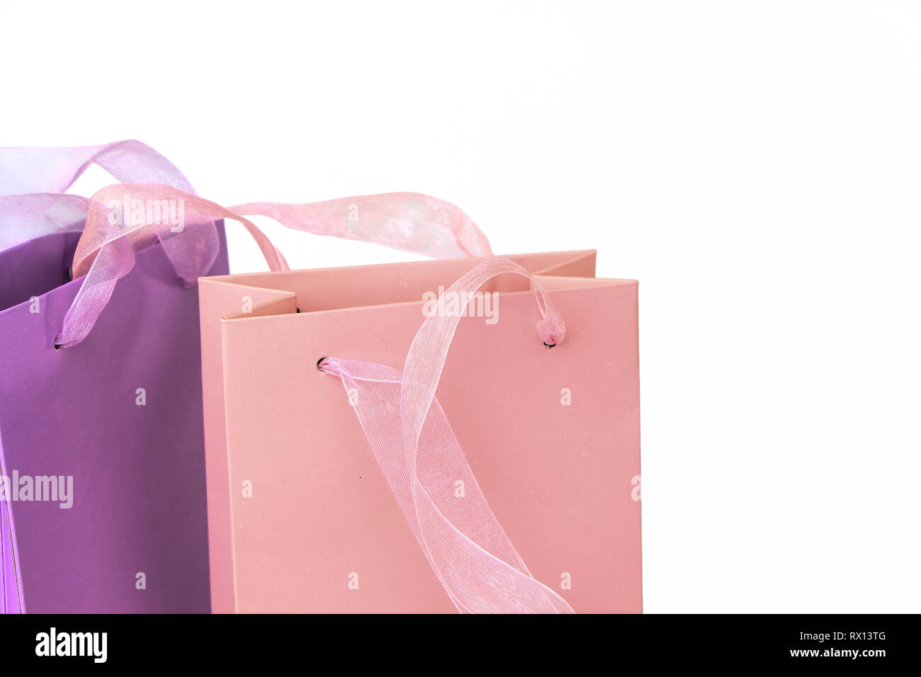 Pastel pink and lilac colorful shopping bags tops closeup isolated ...