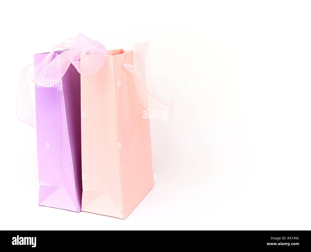Pastel pink and lilac shopping bags isolated on white Stock Photo - Alamy