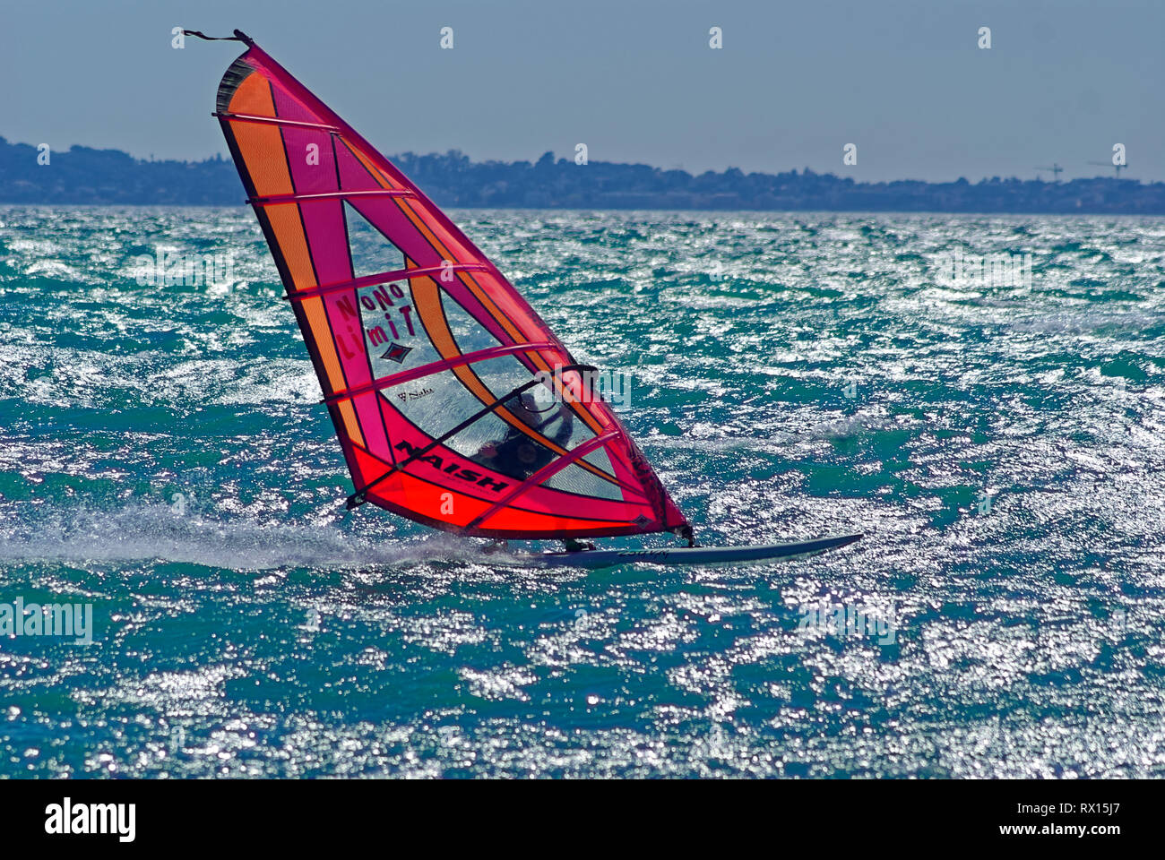 windsurfer at full speed during a strong windy day in mediterranean sea (St Laurent du Var , France) Stock Photo