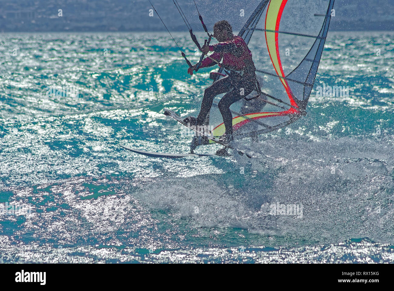 Kiteboarder vs windsurfer  in mediterranean sea during a windy day Stock Photo