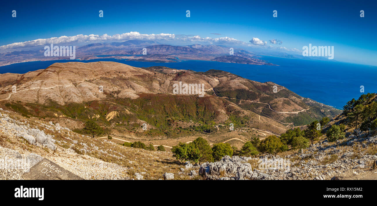 Aerial view over mountains to the rural road and Ionian sea, Pantokrator mountain foothill, Corfu, Greece Stock Photo