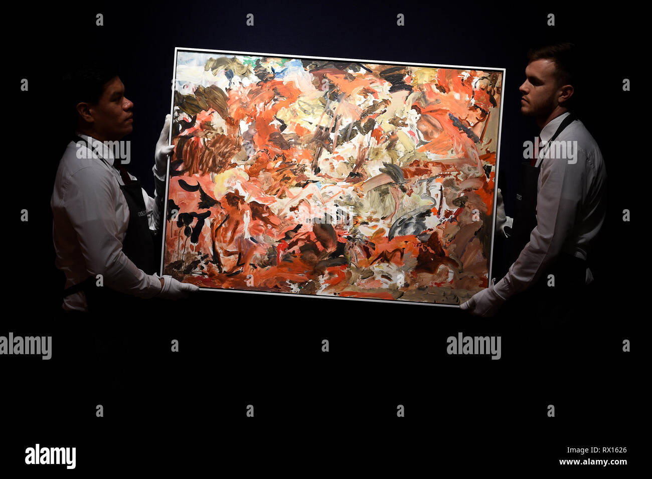 Embargoed to 2300 Friday March 8 Art handlers adjust Yet to be titled by Cecily Brown stands behind The Incomplete Truth by Damien Hirst, during a photo call for The George Michael Collection art sale at Christie's, London. Stock Photo