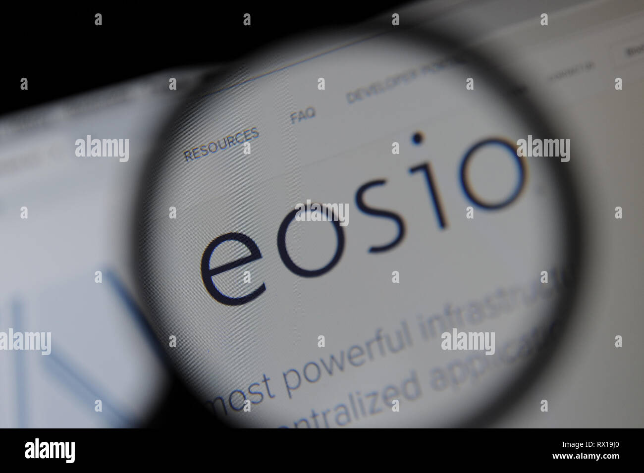 The EOSIO website seen through a magnifying glass Stock Photo