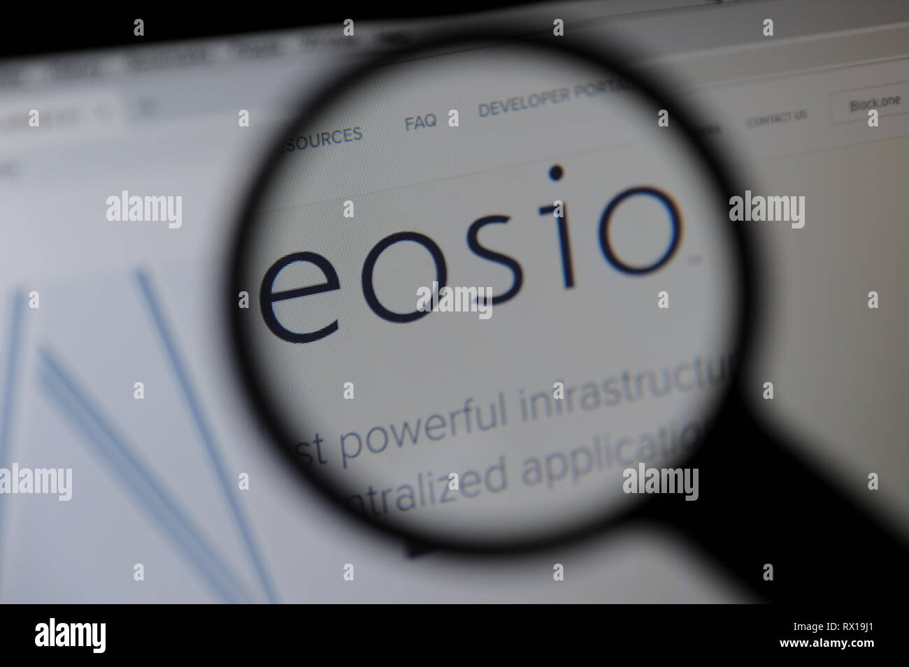 The EOSIO website seen through a magnifying glass Stock Photo