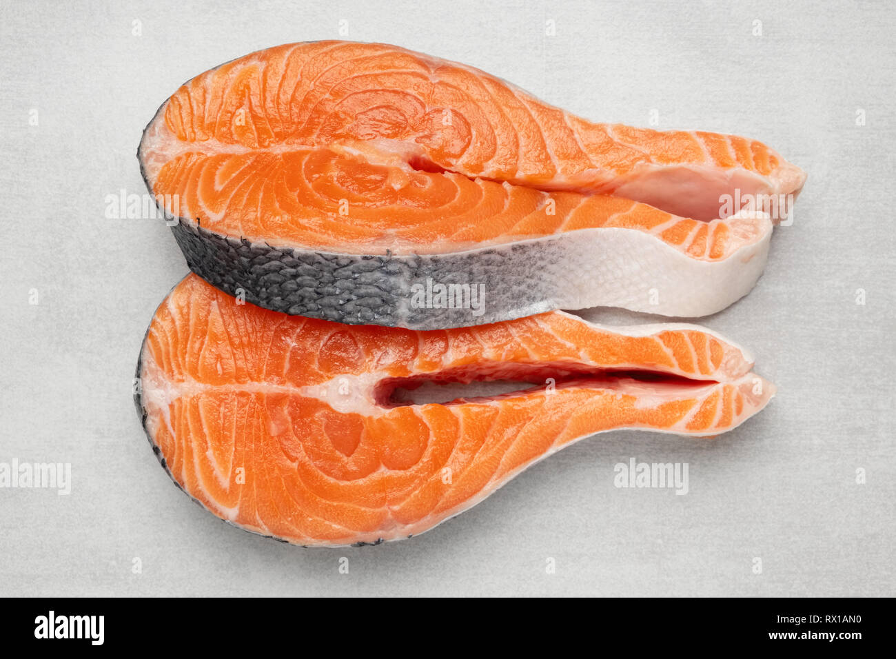 Fresh raw salmon fish steaks on natural stone background. Top view ...