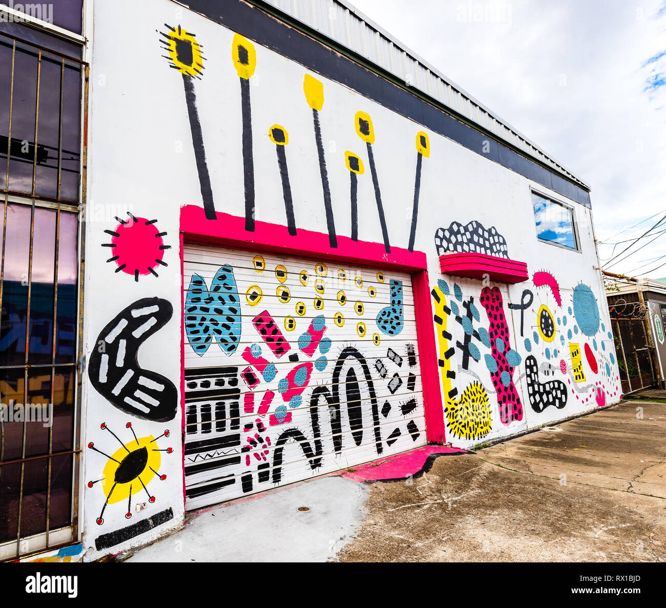 Graffiti on the front of a bakery building by some talented artists in