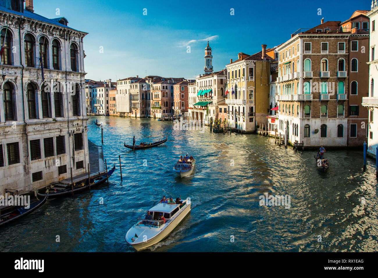 Venice/Italy - 5 June, 2012: The view of Grand Canal with gondoliers and tourist boats from Rialto Bridge. Stock Photo
