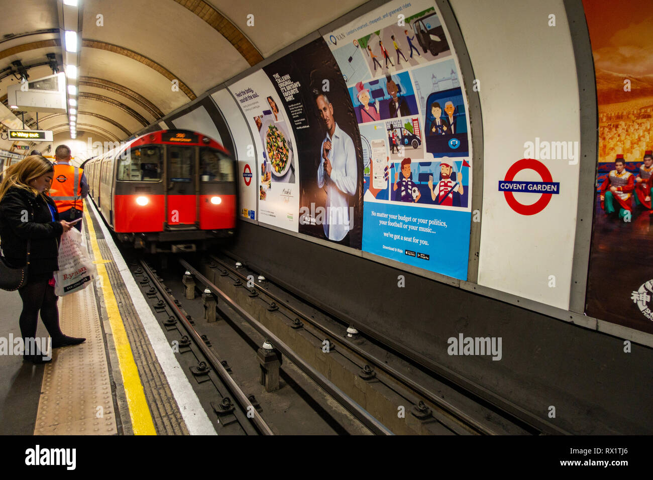 Female Commuter Waits For The Approaching Tube Train On London Underground Track With Ad Poster Stock Photo Alamy Female Commuter Waits For The Approaching Tube Train On London Underground Track With Ad Poster Stock Photo Alamy