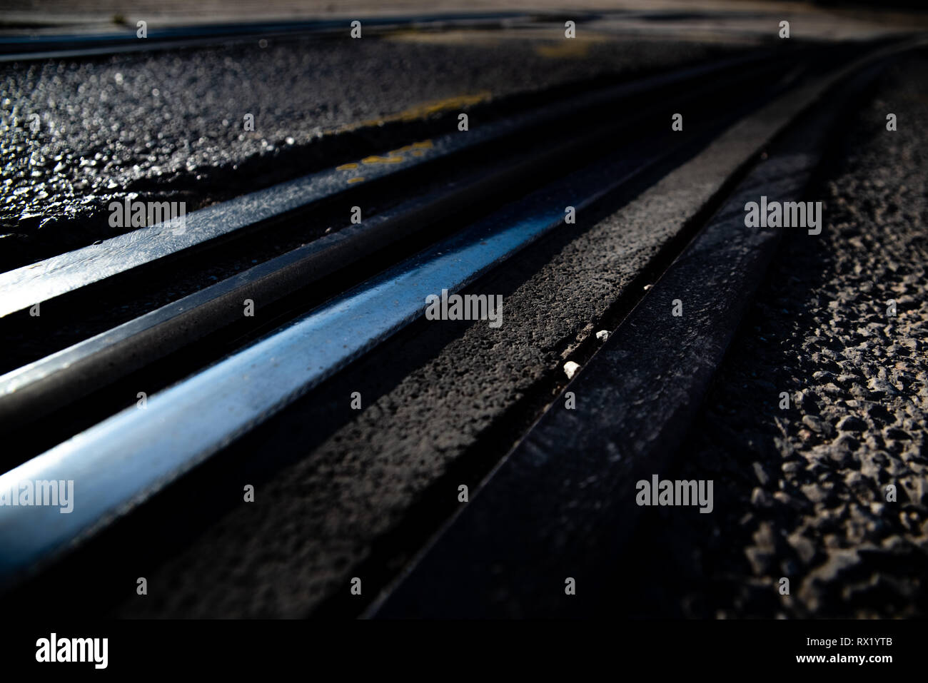 Tracks of an urban tram between the asphalt of a street Stock Photo - Alamy