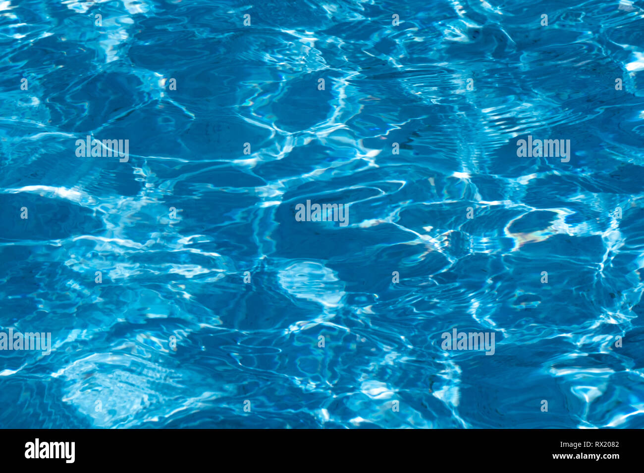 Blue and bright ripple clean water surface in swimming pool with sun ...