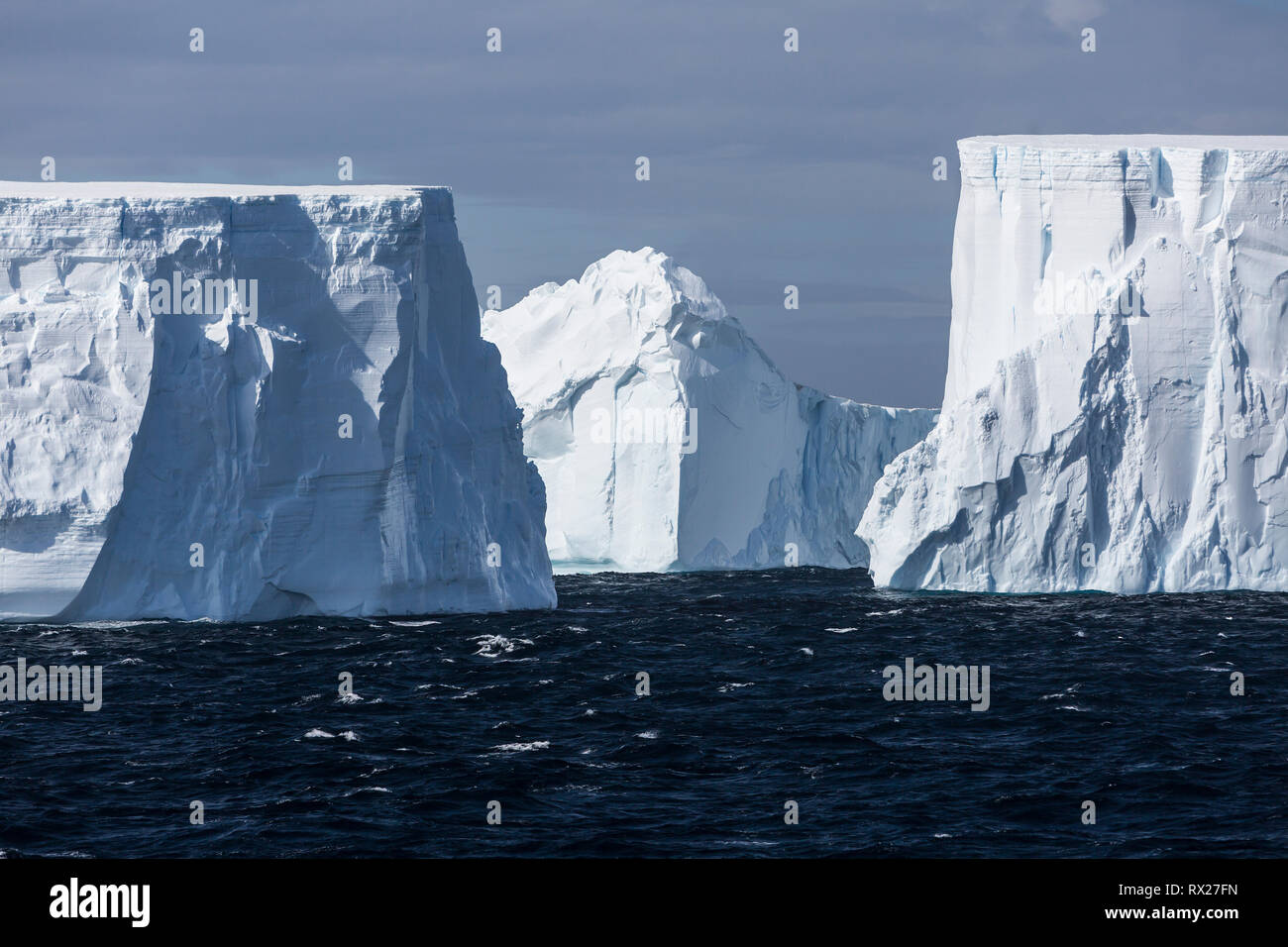 Incredibly large tabular icebergs float through the antarctic Sound near the top of the Antarctic Peninsula, Antarctica Stock Photo