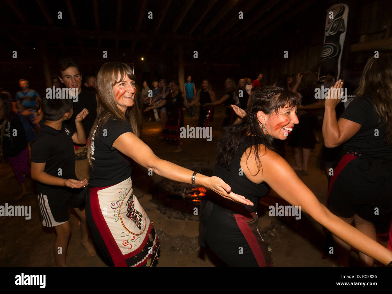 Visitors to the Komok's bighouse celebrate with dancers with the Kumugwe dance troupe during aboriginal days. Comox, The Comox Valley, Vancouver Islan Stock Photo