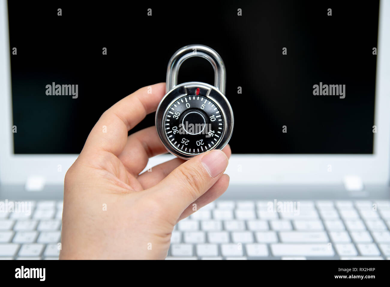 Computer security concept, padlock on laptop keyboard. Stock Photo