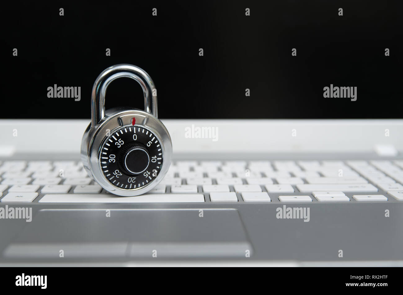 Computer security concept, padlock on laptop keyboard. Stock Photo