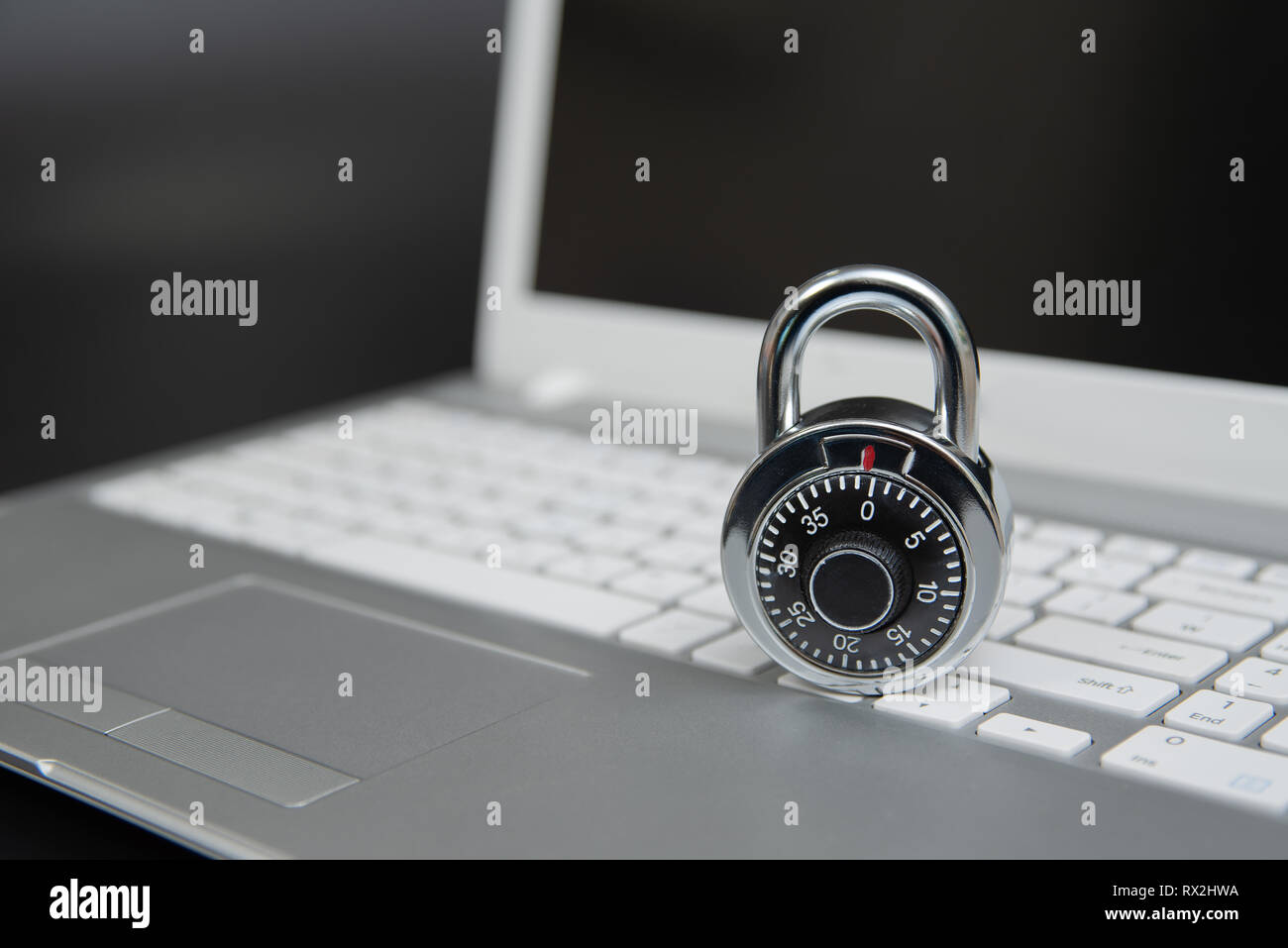 Computer security concept, padlock on laptop keyboard. Stock Photo