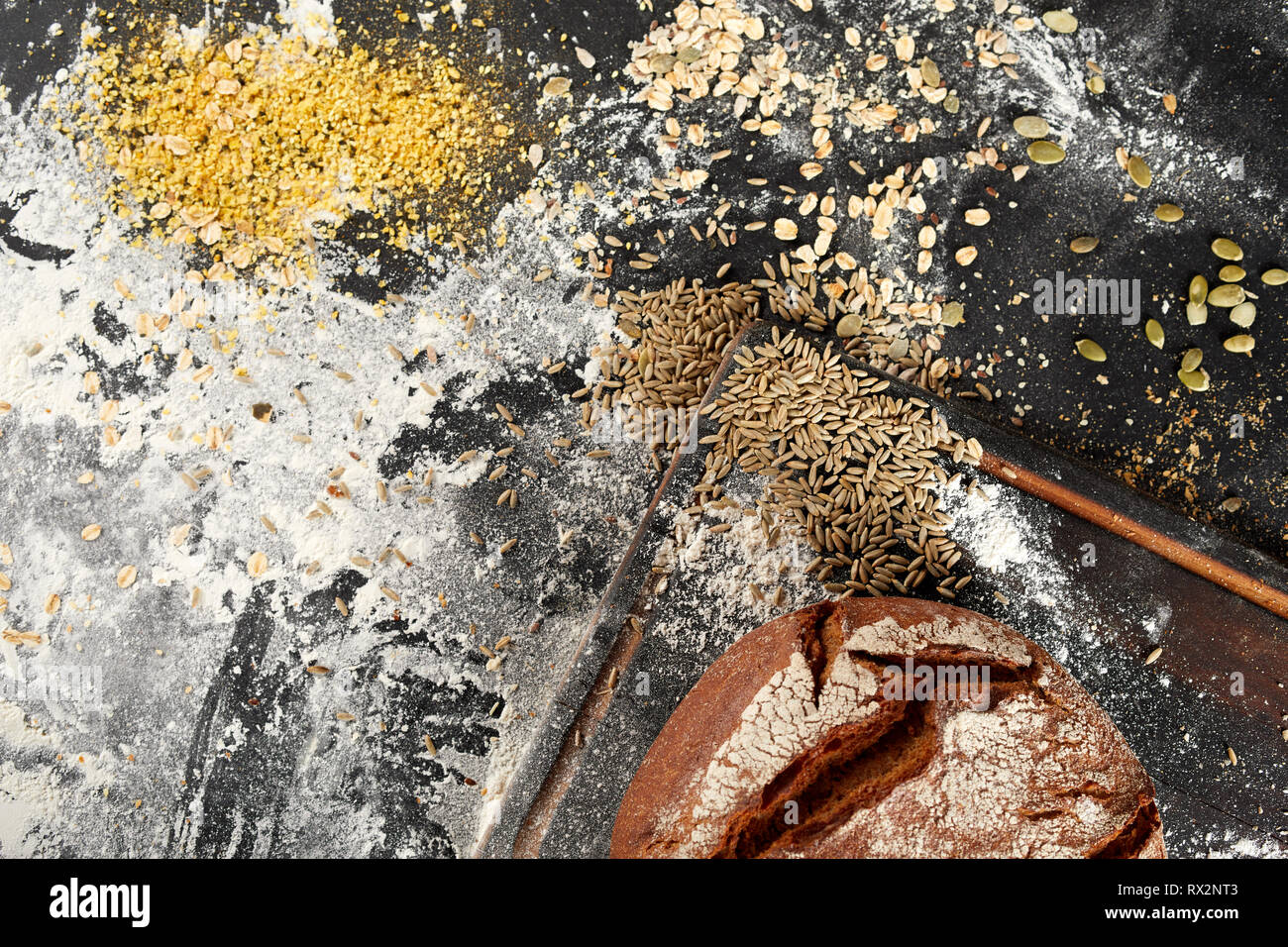 Assorted grain seeds with a freshly baked crusty loaf of bread and ...