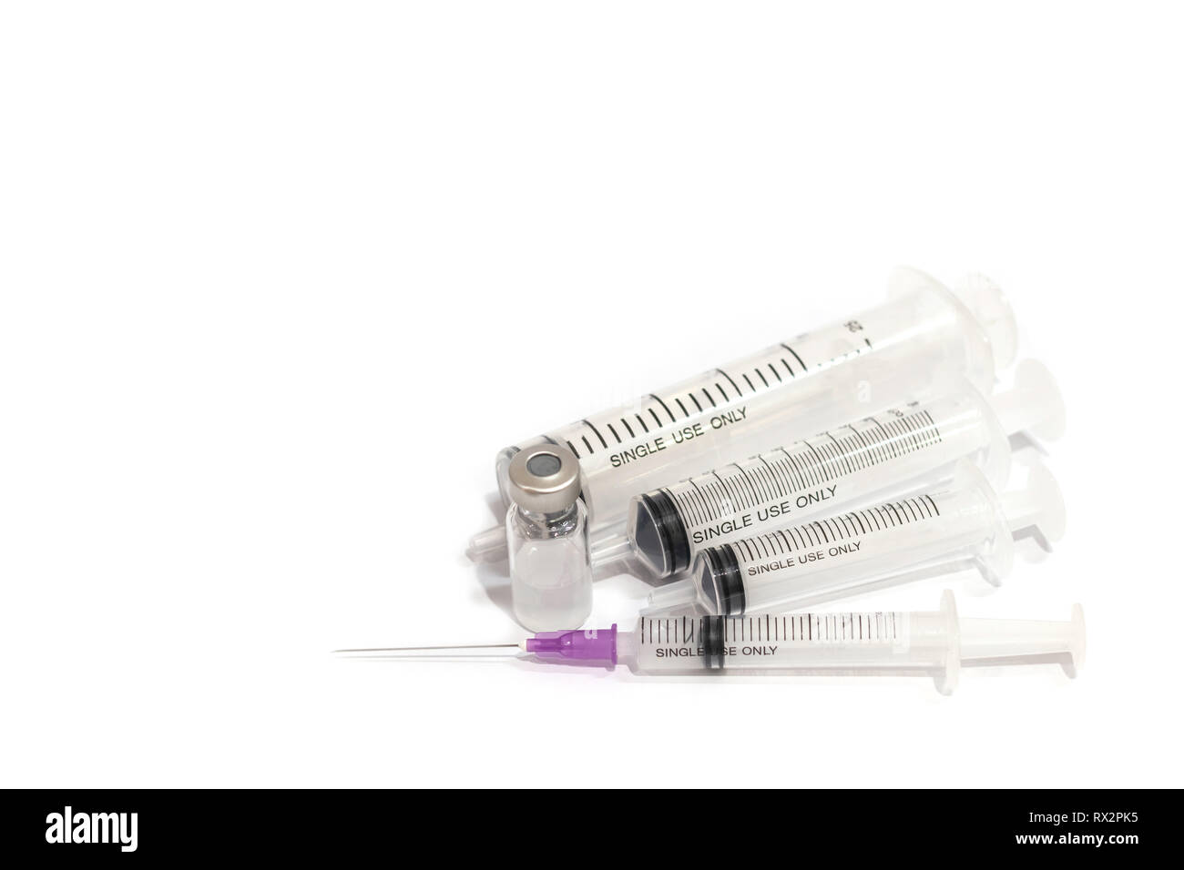 Vials with medication and injection needle isolated on white background