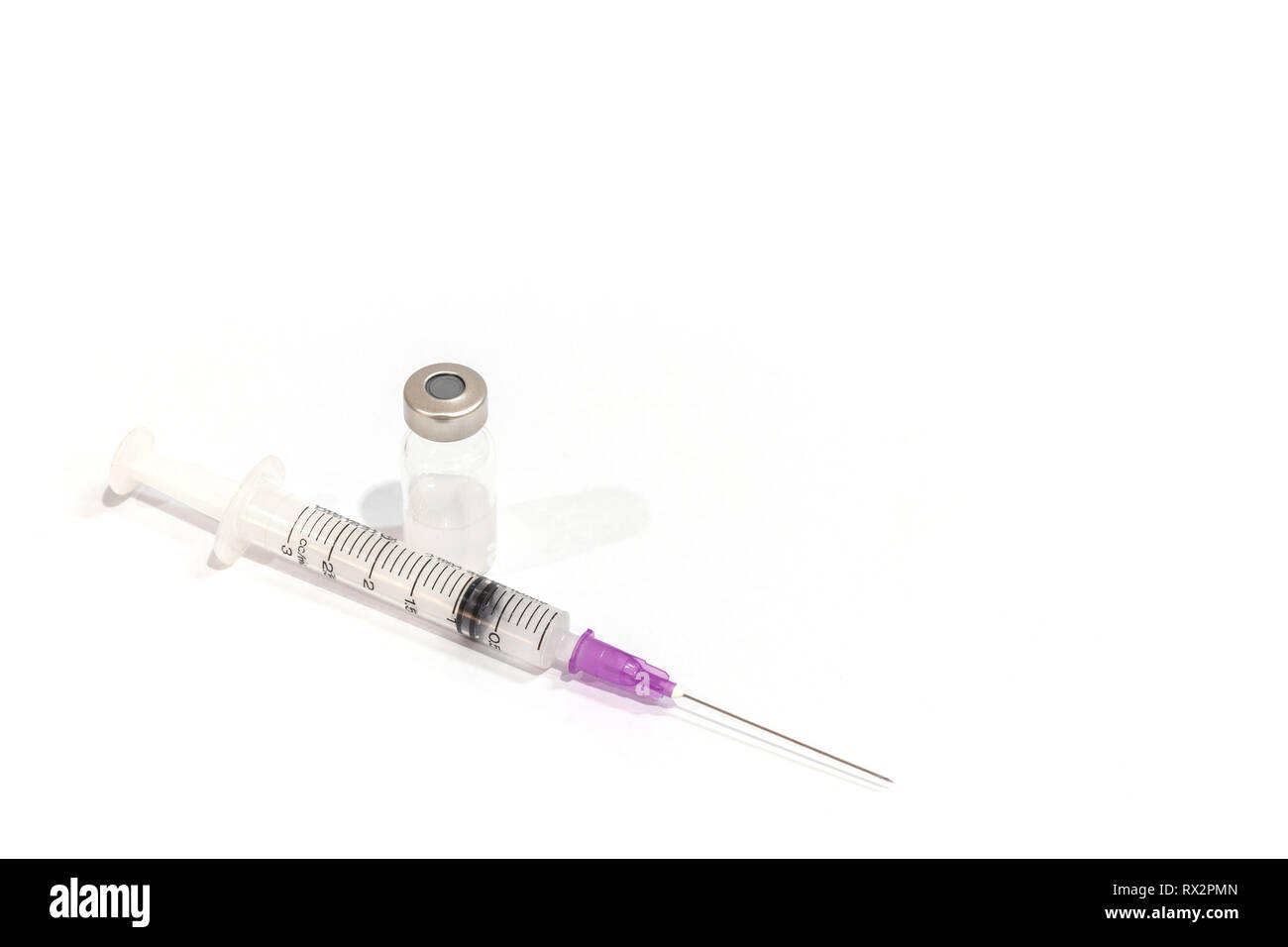 Vials with medication and injection needle isolated on white background. Stock Photo
