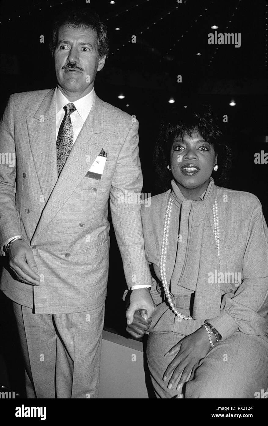 Oprah Winfrey and Alex Trebek Attending the N.A.T.P.E. TV Convention in New Orleans. January 1990 Credit: Walter McBride/MediaPunch Stock Photo