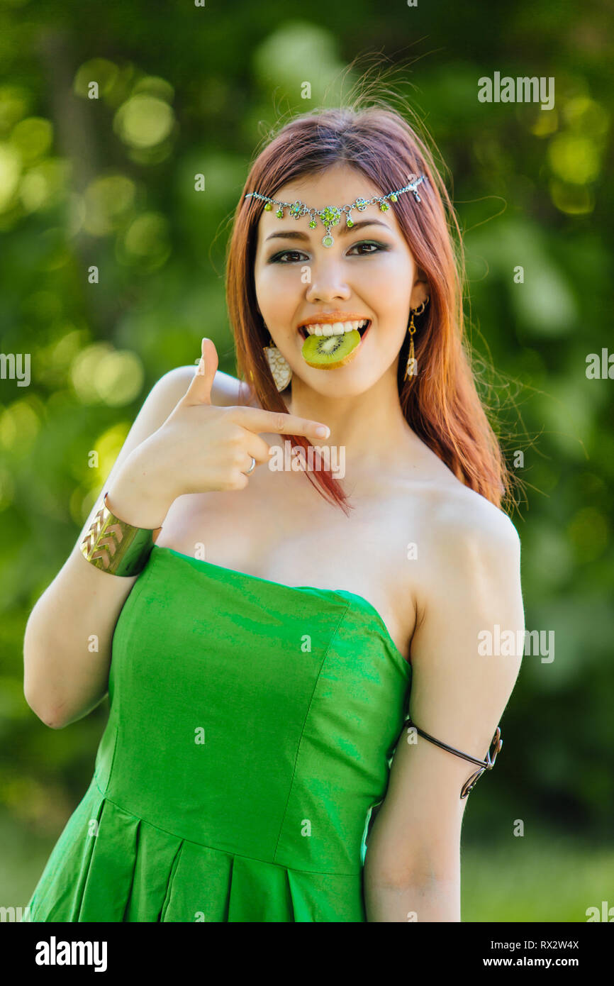 Portrait of a beautiful young asian woman in green dress and diadema on ...