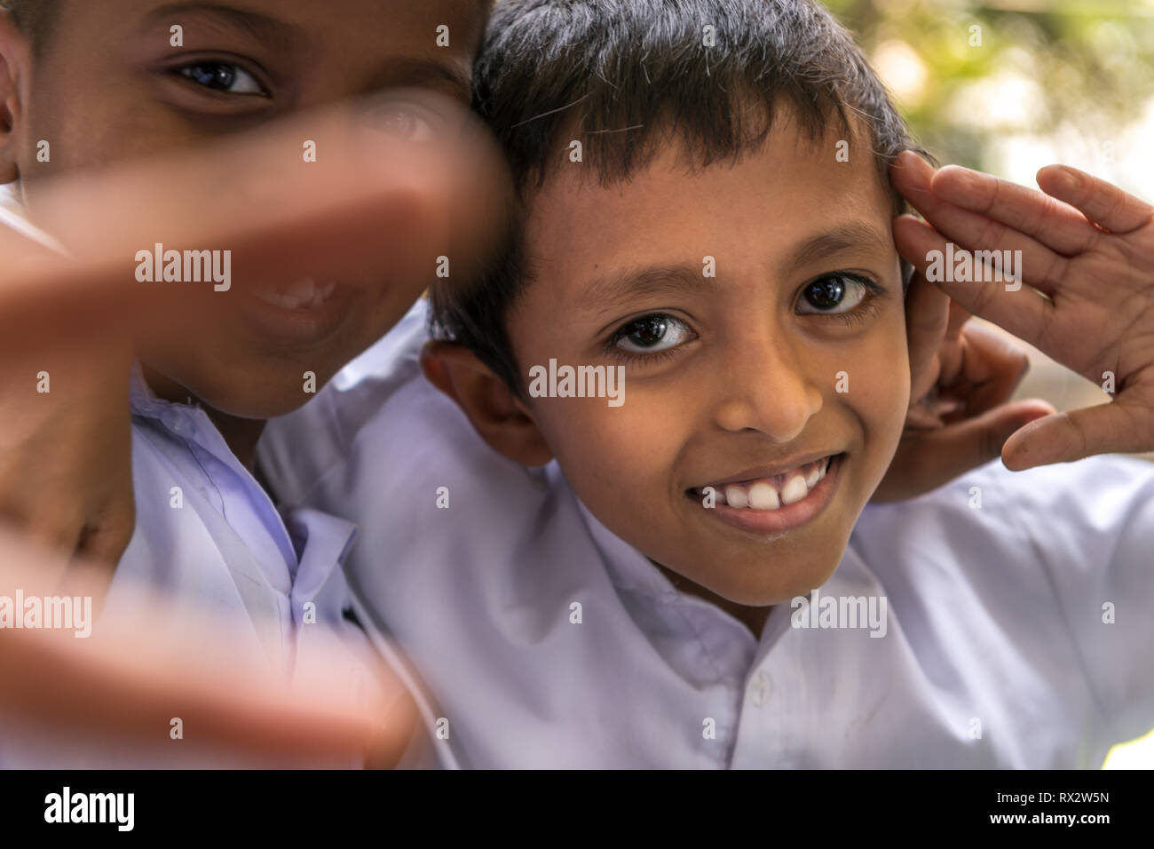 Children take time out from Sunday School to pose for the camera at the famous Gangaramaya Buddhist Temple in Colombo Sri Lanka. Stock Photo