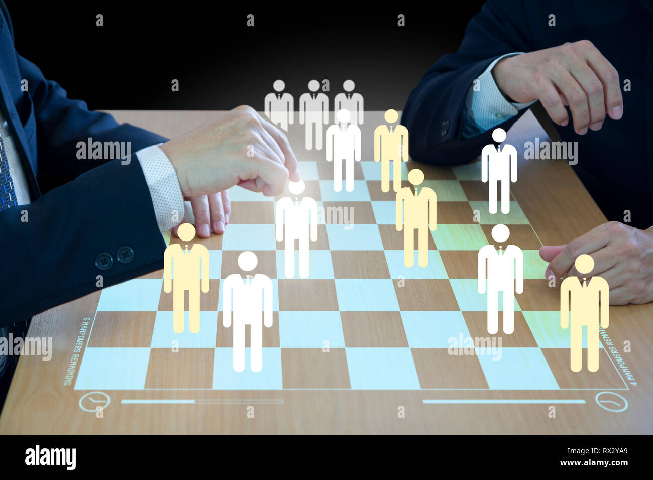 Three business administrators playing checkers or draughts on a wooden virtual checkerboard or draughtboard in concept of manpower or human resource. Stock Photo