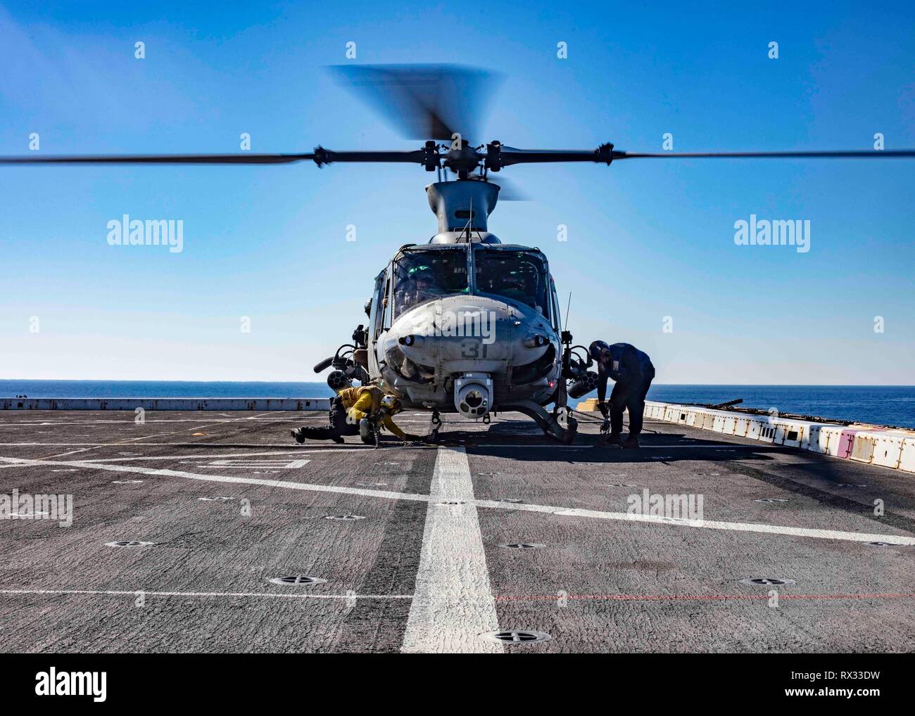 190305-N-HG389-0049 MEDITERRANEAN SEA (Mar. 5, 2019) Sailors secure a UH-1Y Huey helicopter assigned to the “Black Knights” of Marine Medium Tiltrotor Squadron (VMM) 264 (Reinforced) to the flight deck of the San Antonio-class amphibious transport dock ship USS Arlington (LPD 24), Mar. 5, 2019. Arlington is on a scheduled deployment as part of the Kearsarge Amphibious Ready Group in support of maritime security operations, crisis response and theater security cooperation, while also providing a forward naval presence. (U.S. Navy photo by Mass Communication Specialist 2nd Class Brandon Parker/R Stock Photo