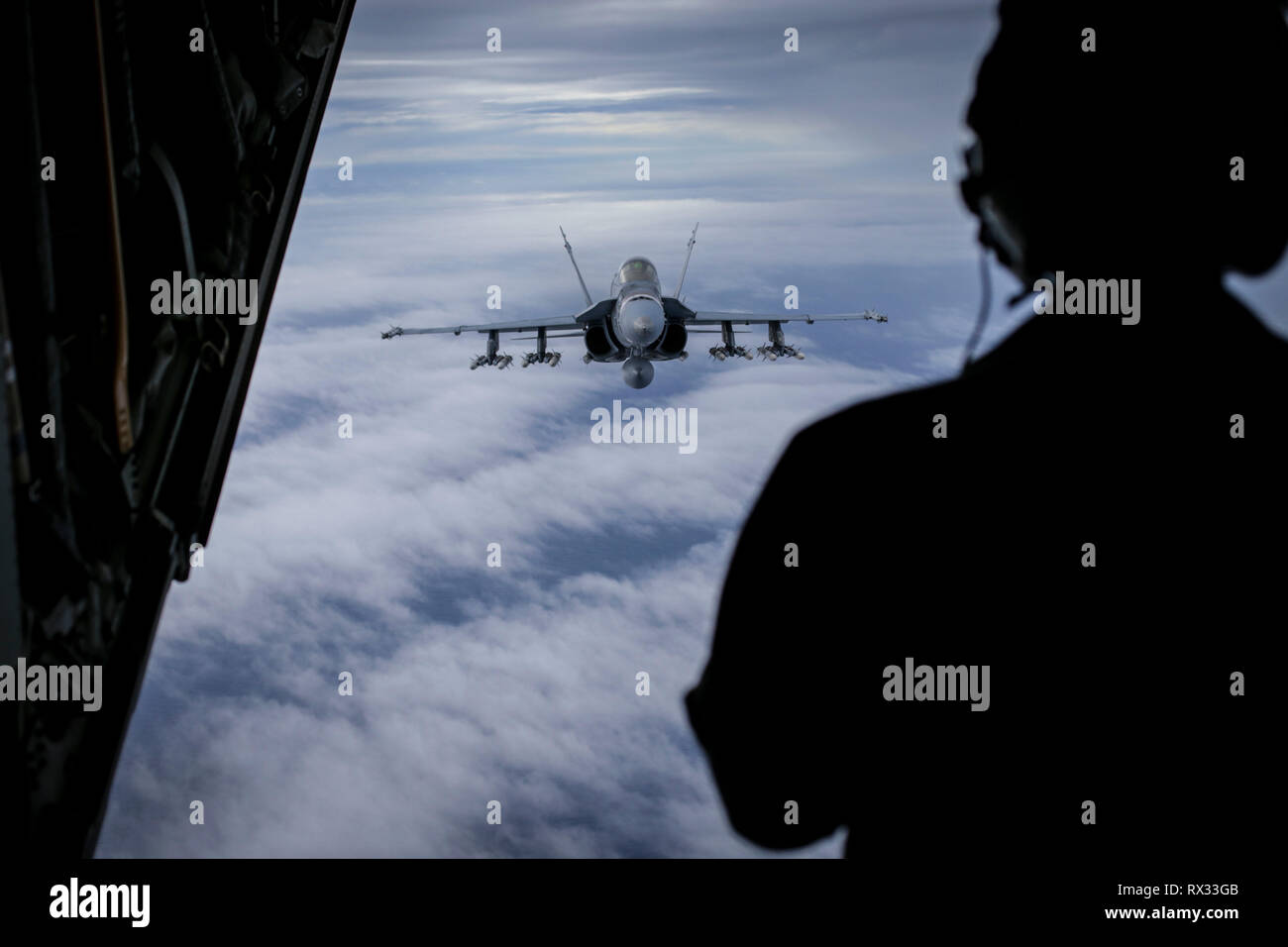 An F/A-18 Hornet with Marine Fighter Attack Squadron (VMFA) 323, MAG-11, 3rd Marine Aircraft Wing (MAW), carrying ten AIM-120 and two AIM-9X Air-to-Air missiles, prepares to refuel prior to a training mission over the W-291 training area in southern California, March 6. MAG-11 supports and integrates aviation combat power and capabilities while enhancing 3rd MAW's ability generate lethality for the supported Marine Air-Ground Task Force (MAGTF). (U.S Marine Corps photo by Sgt. David Bickel) Stock Photo
