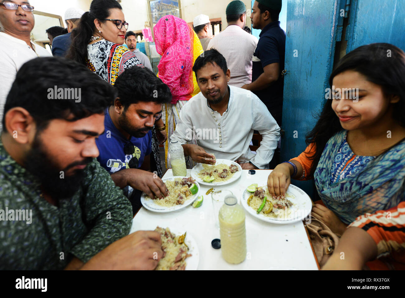 Fashionable young Bangladeshis enjoying their Biriyani at the Original Haji Biryani in old Dhaka. Stock Photo