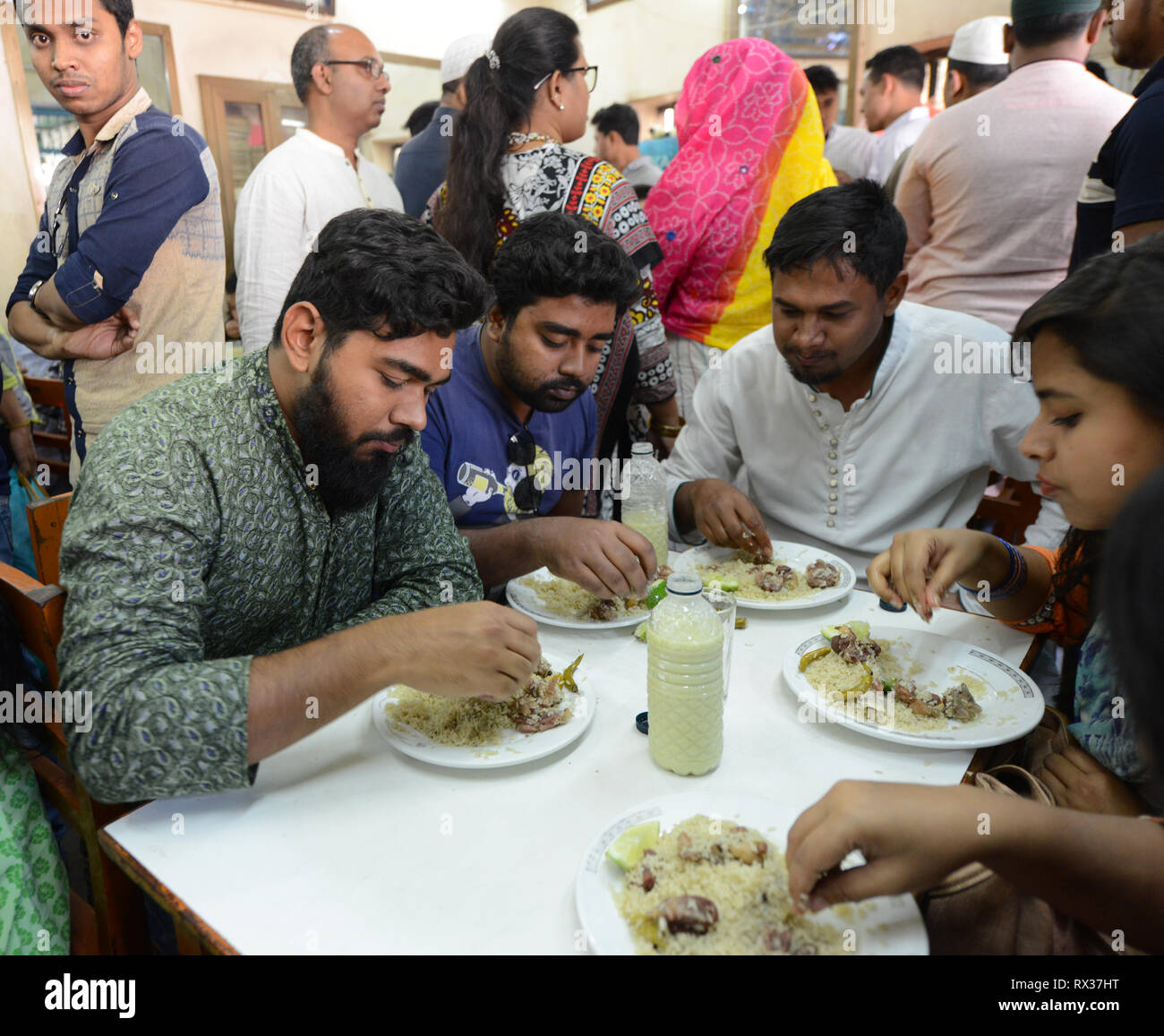 Fashionable young Bangladeshis enjoying their Biriyani at the Original Haji Biryani in old Dhaka. Stock Photo