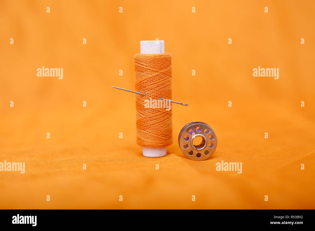 Portrait of bobbins and sewing thread with needle . Isolated on the ...