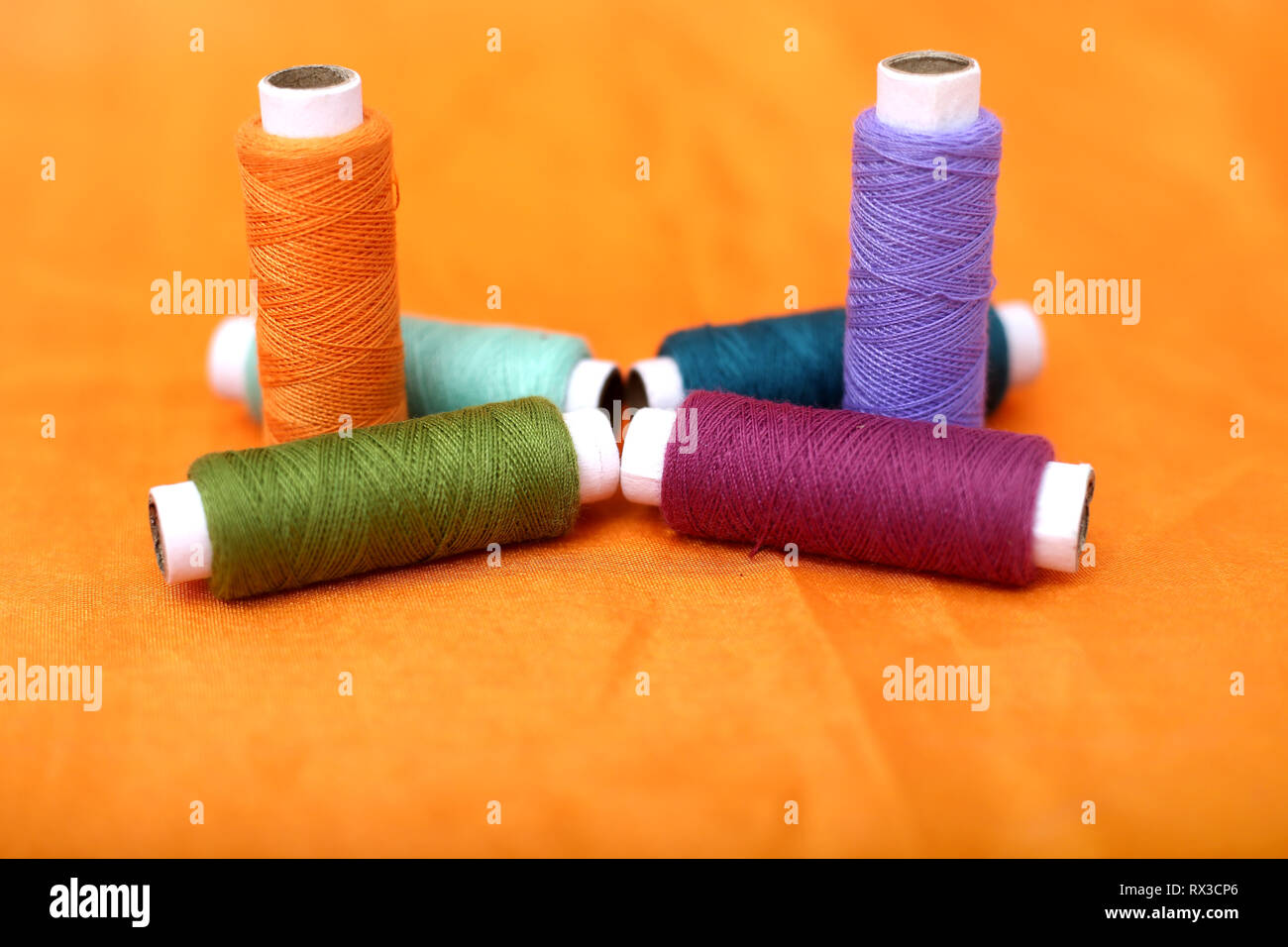Photo of colored sewing thread. Isolated on the yellow background Stock ...