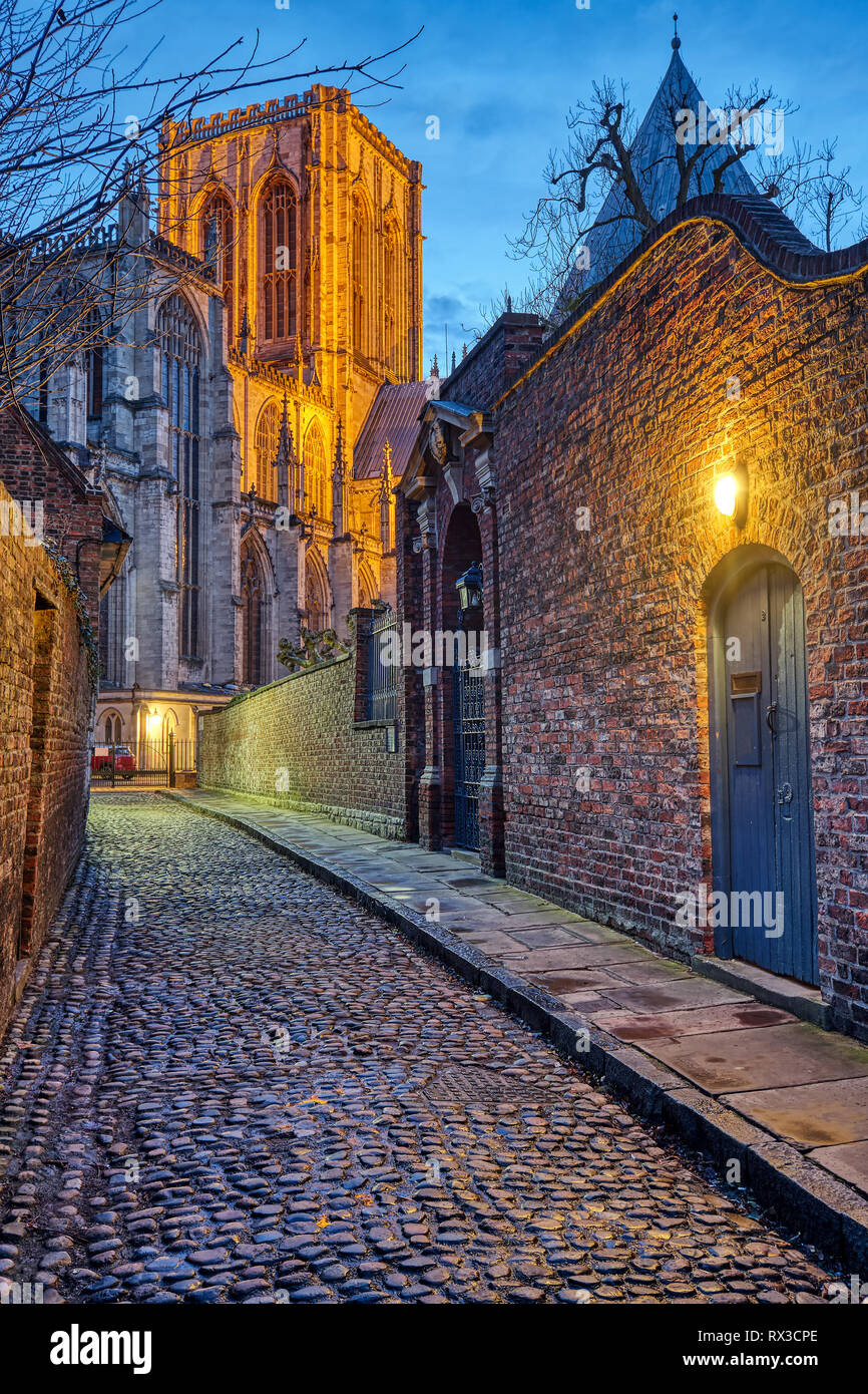 Small cobbled street in York at night with the famous Minster in the back Stock Photo