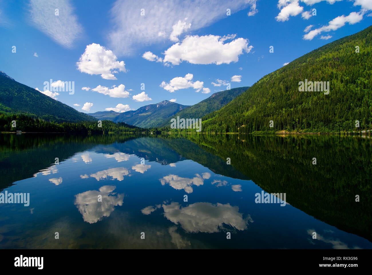 Perfect spring time conditions over a calm Three Valley Lake, Three Valley Gap, near Reveltoke, British Columbia, Canada Stock Photo