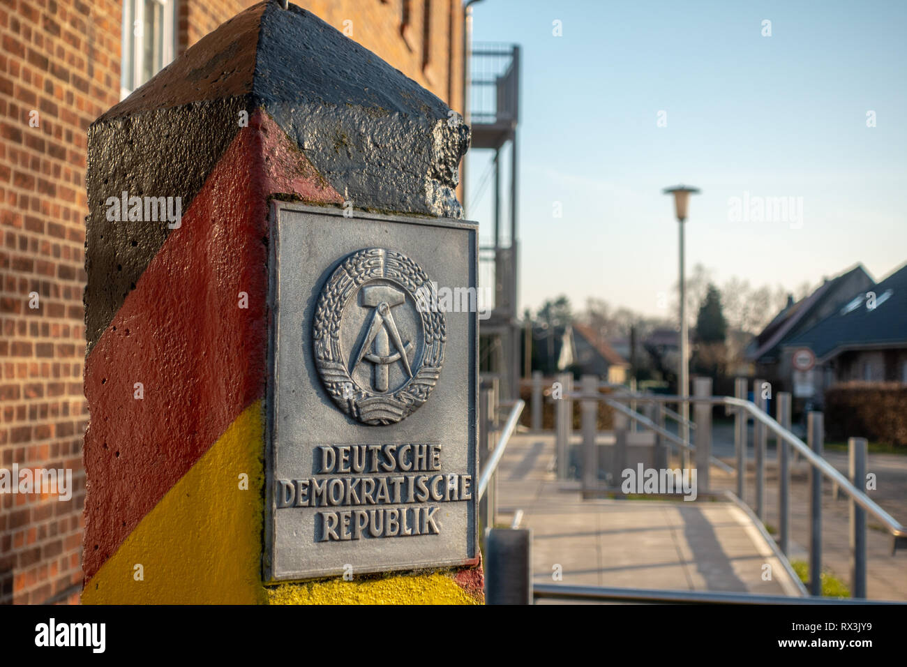 a pole with the coat of arms of the GDR stands in a village Stock Photo