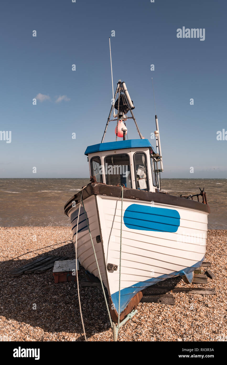 Fishing boat pebbled beach Stock Photo - Alamy