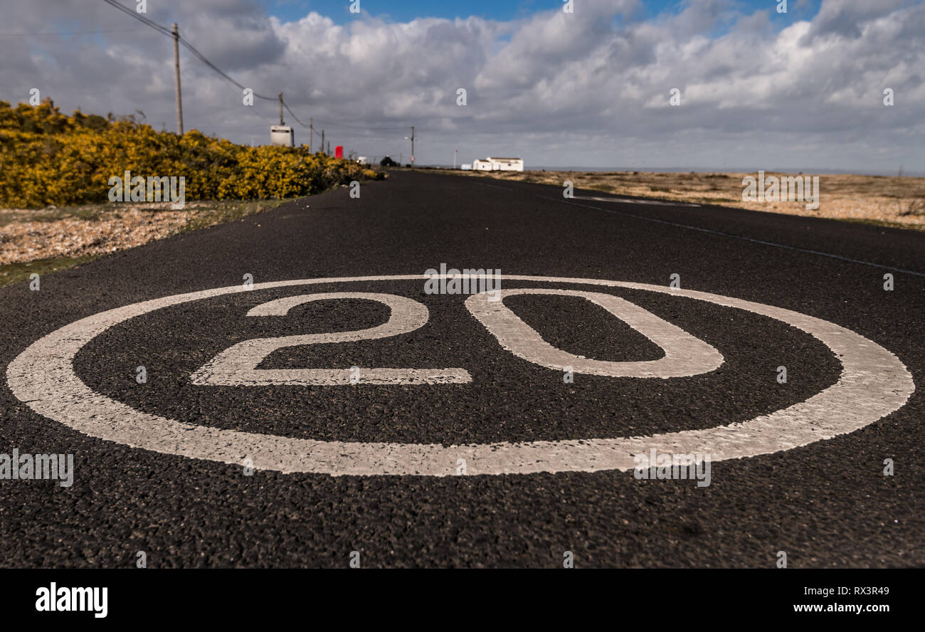 20 mph speed limit painted on road Stock Photo