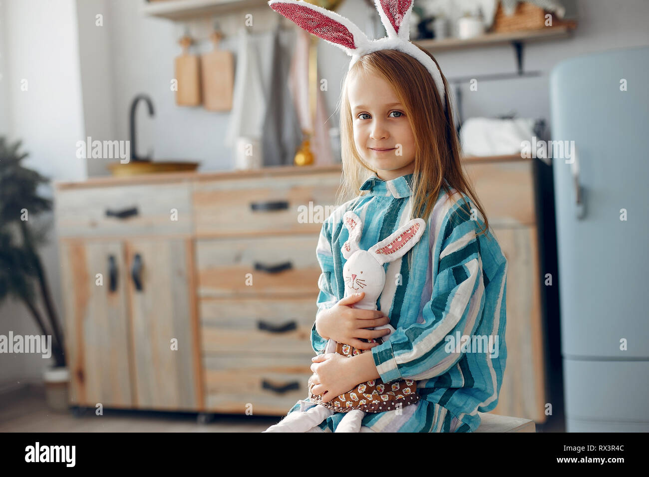 Cute little girl sitting at home Stock Photo - Alamy