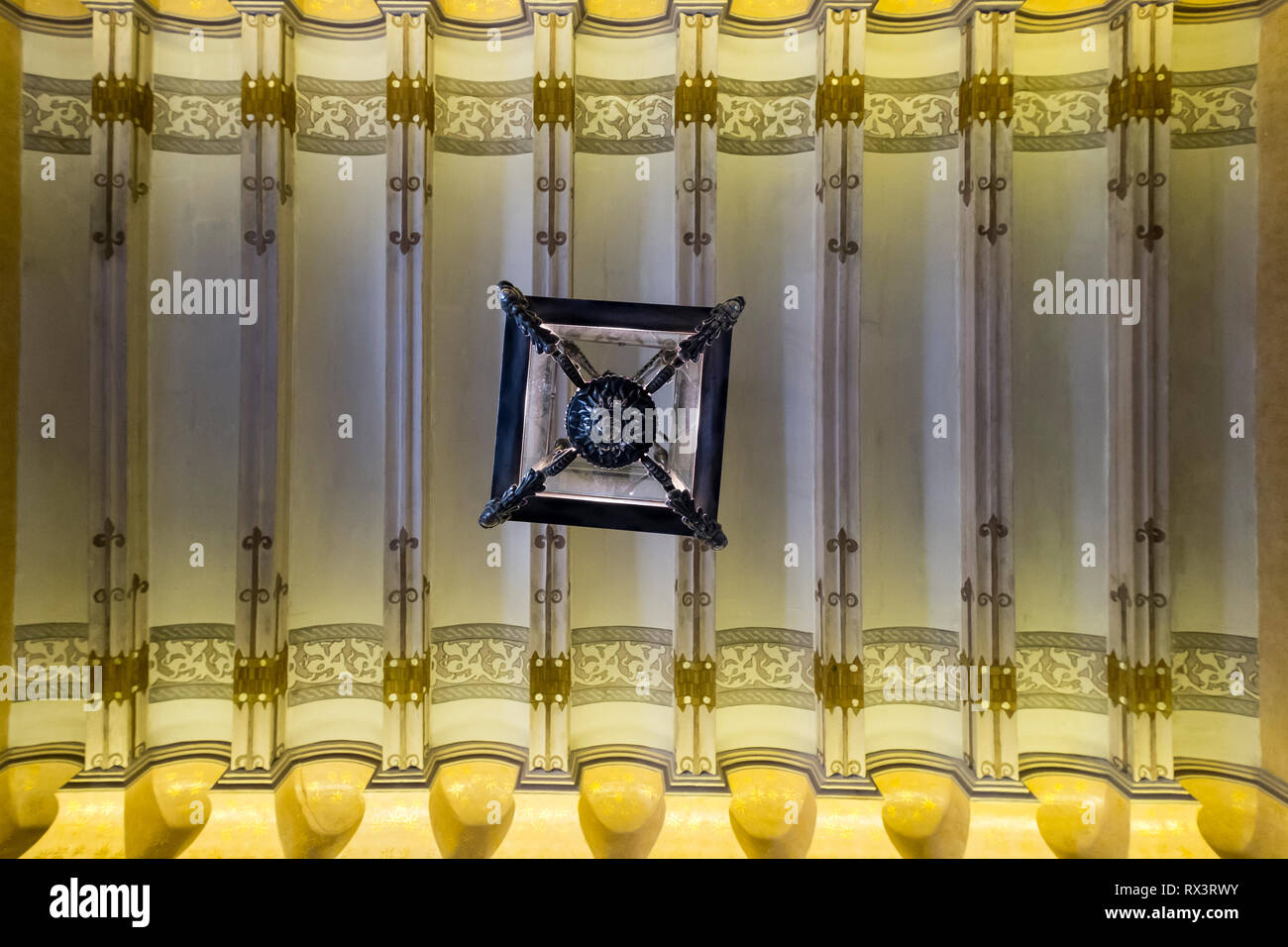 Light fixture and painted ceiling at the Gaudi House Museum in