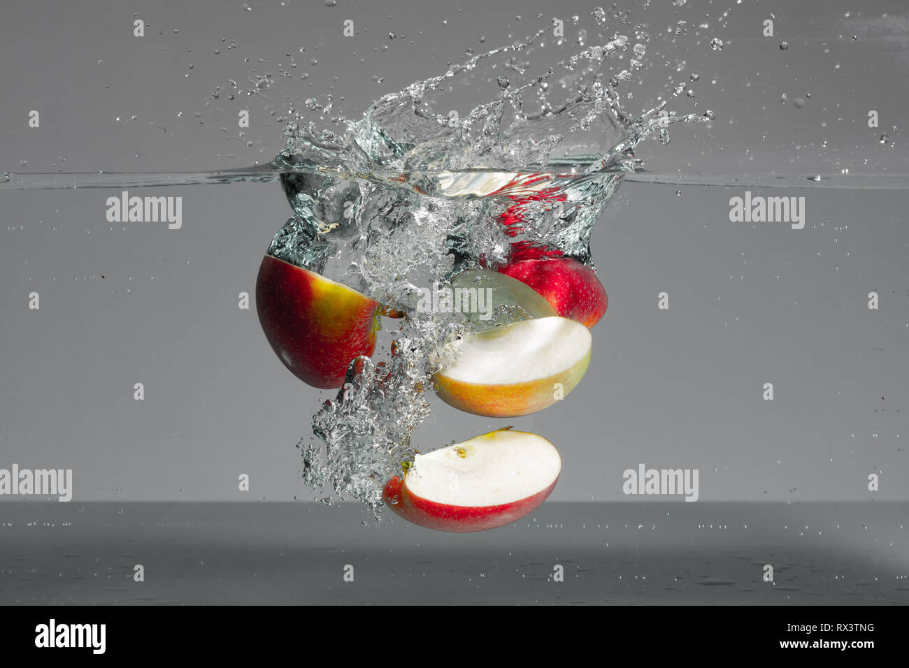 Red Apple Slices Fall Into Water And Create Beautiful Air Bubbles And Water Splashes Stock Photo Alamy