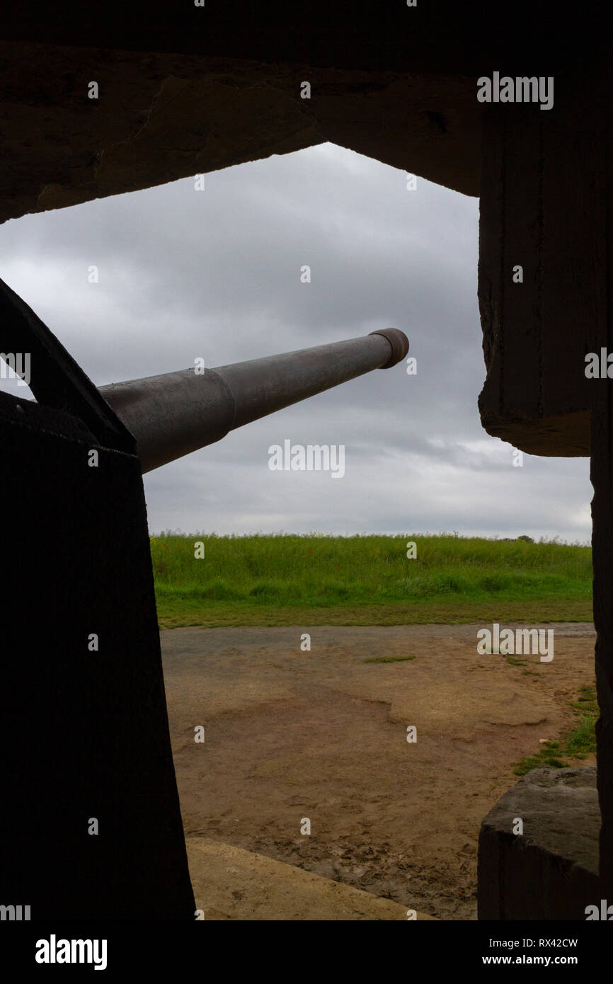 Looking out from a 50mm gun in one of the four casements of the Longues-sur-Mer Battery, situated west of Arromanches-les-Bains in Normandy, France. Stock Photo