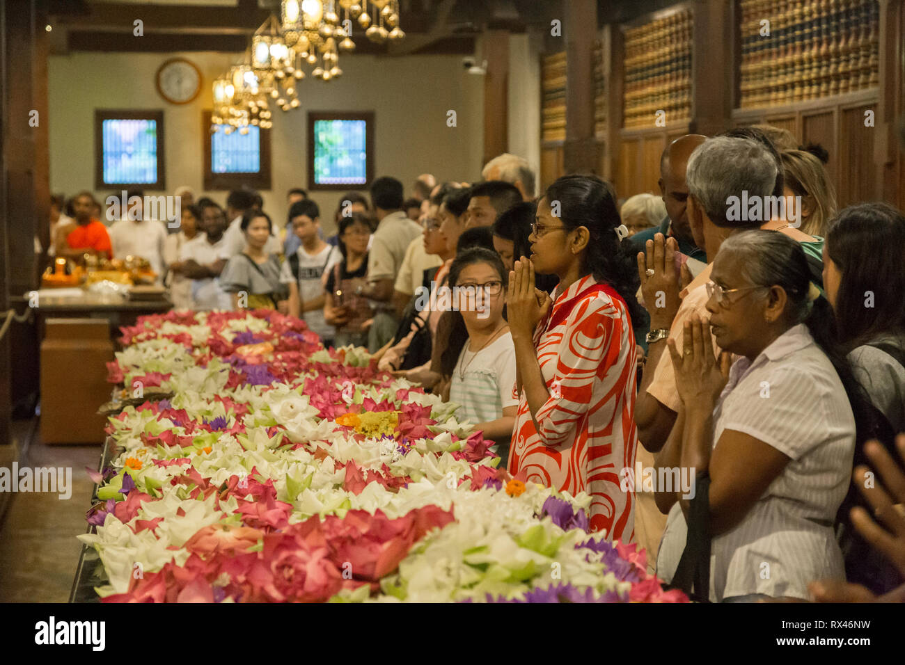 Pilgrims inside Temple of the Tooth in Kandy, Sri Lanka Stock Photo