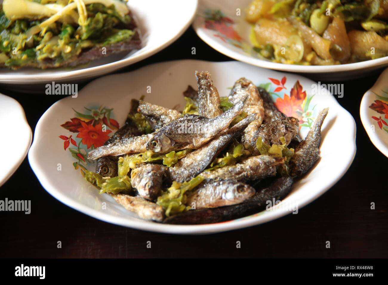 Ikan Bilis. Crispy anchovies with green chili pepper from Padang, West Sumatra Stock Photo