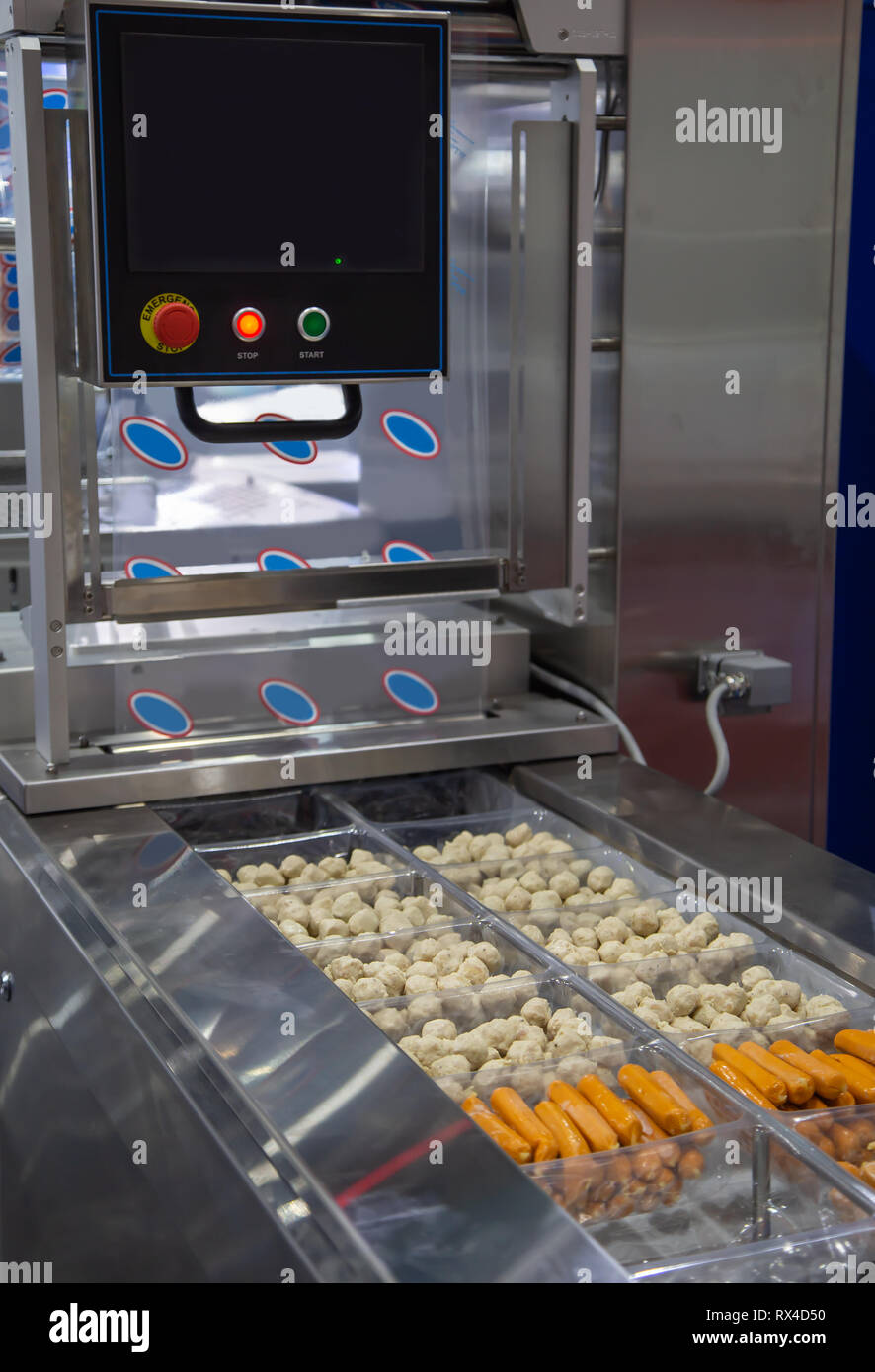 Linear tray food heat sealing and packing machine Stock Photo Alamy