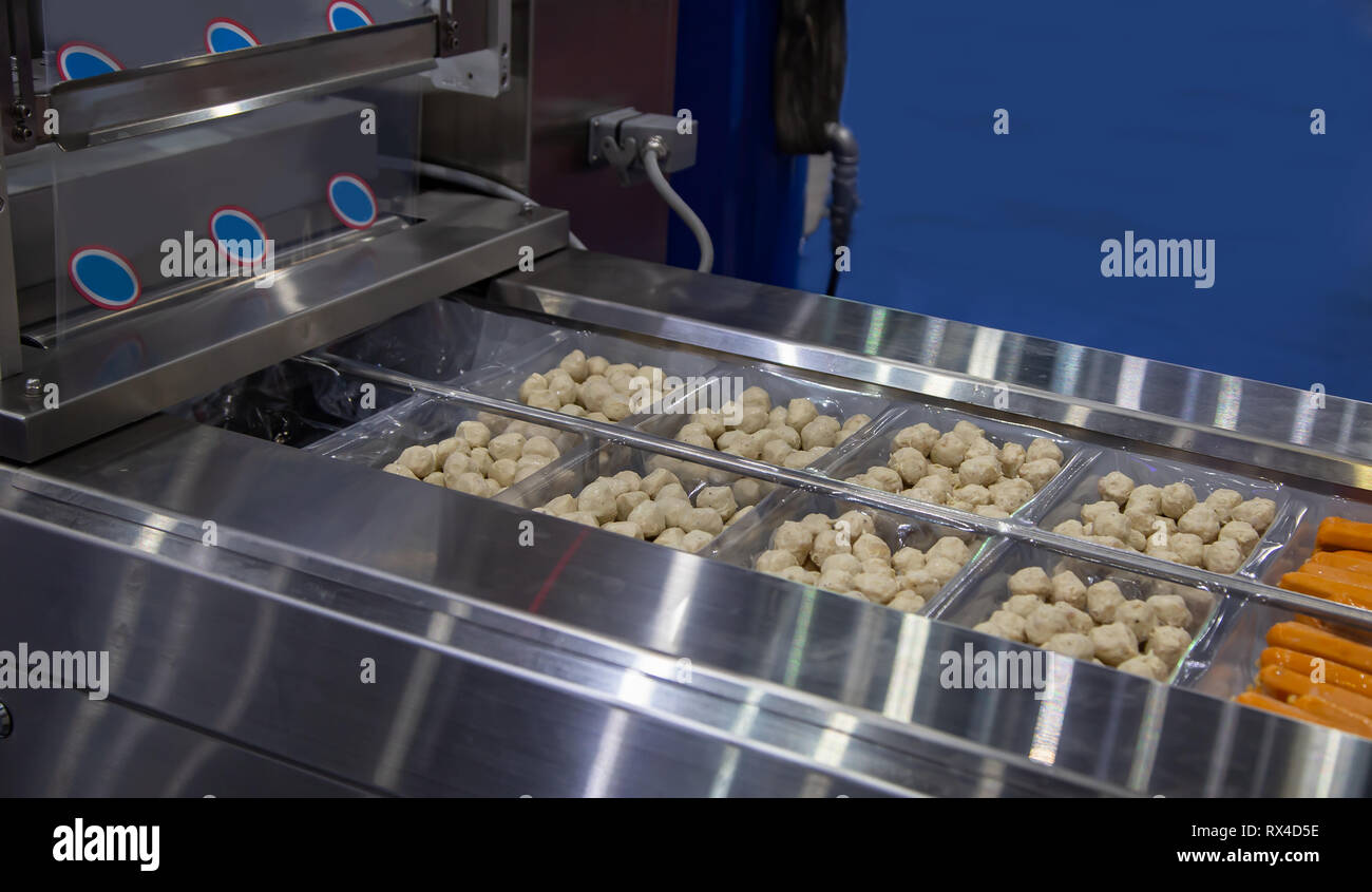 Linear tray food heat sealing and packing machine Stock Photo Alamy