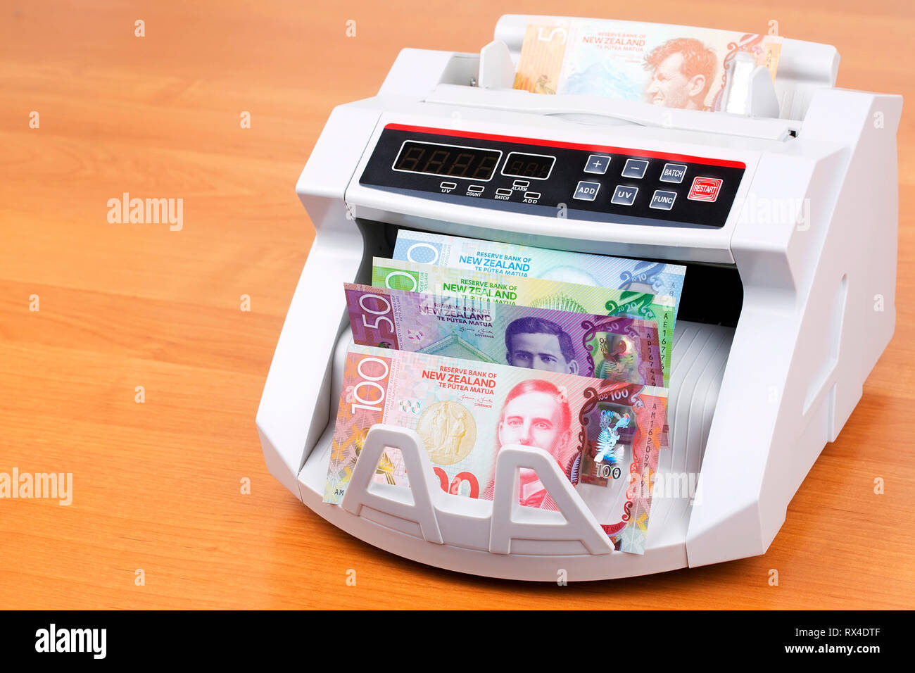 New Zealand dollars in a counting machine Stock Photo Alamy
