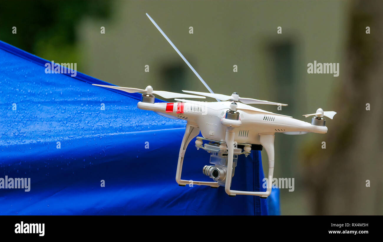A white small drone on standby. An unmanned aerial vehicle commonly known as a drone and also referred to as an unmanned aerial vehicle and a remotely Stock Photo