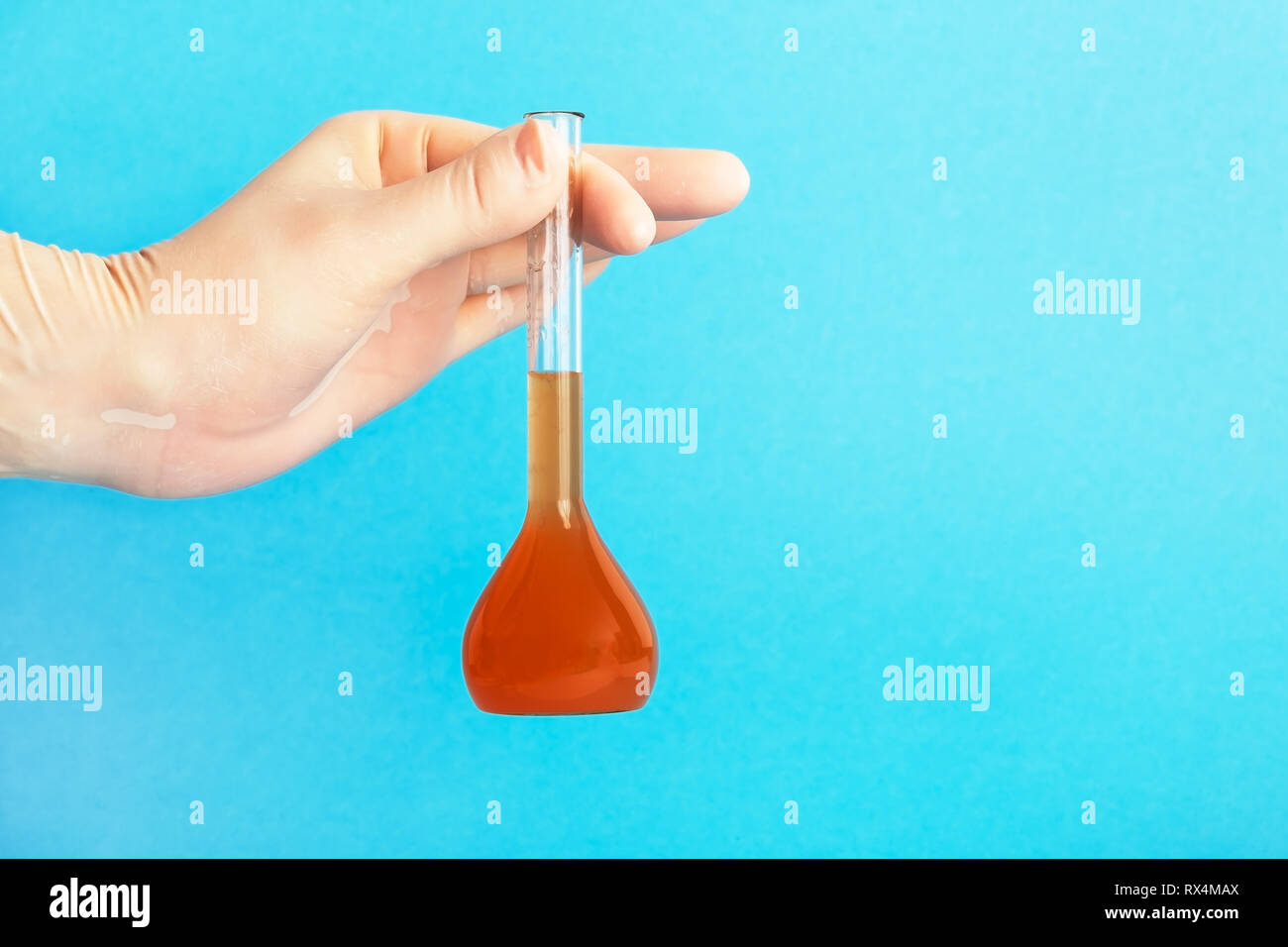 ecologist in protective gloves holding tube with dirty water. Make a