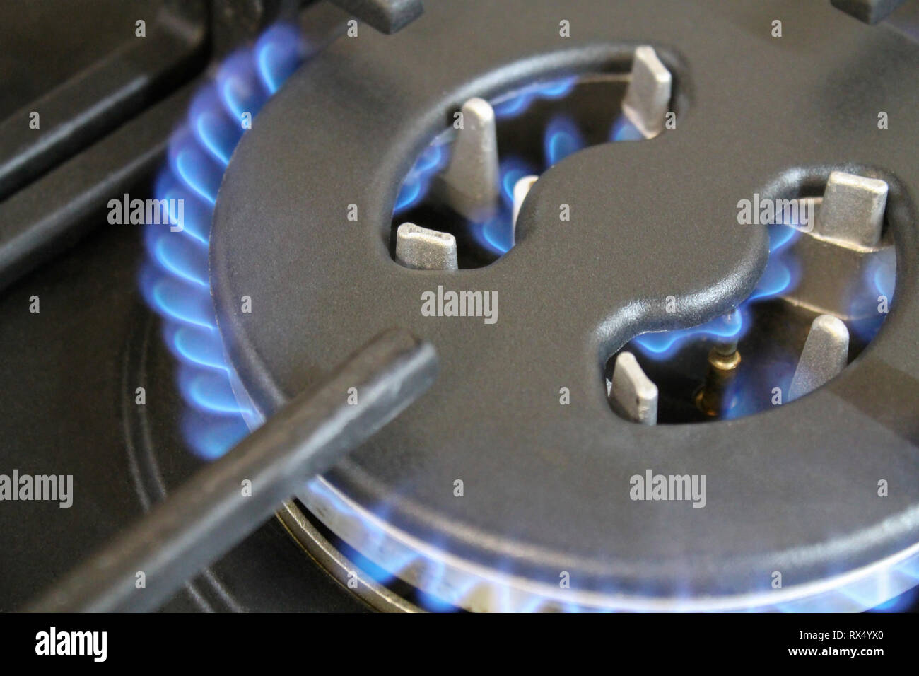 Burning blue flame gas burners cooktop closeup Stock Photo Alamy
