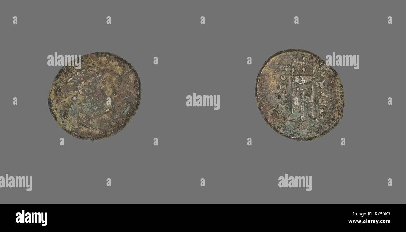 Coin Depicting the God Apollo. Greek. Date: 200 BC-133 BC. Dimensions: Diam. 1.5 cm; 1.91 g. Bronze. Origin: Ancient Greece. Museum: The Chicago Art Institute. Stock Photo
